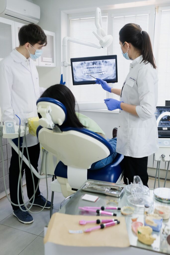 Dentists reviewing a dental X-ray of wisdom teeth in North York