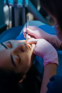 Dentist examining a patient to decide between a crown and a filling