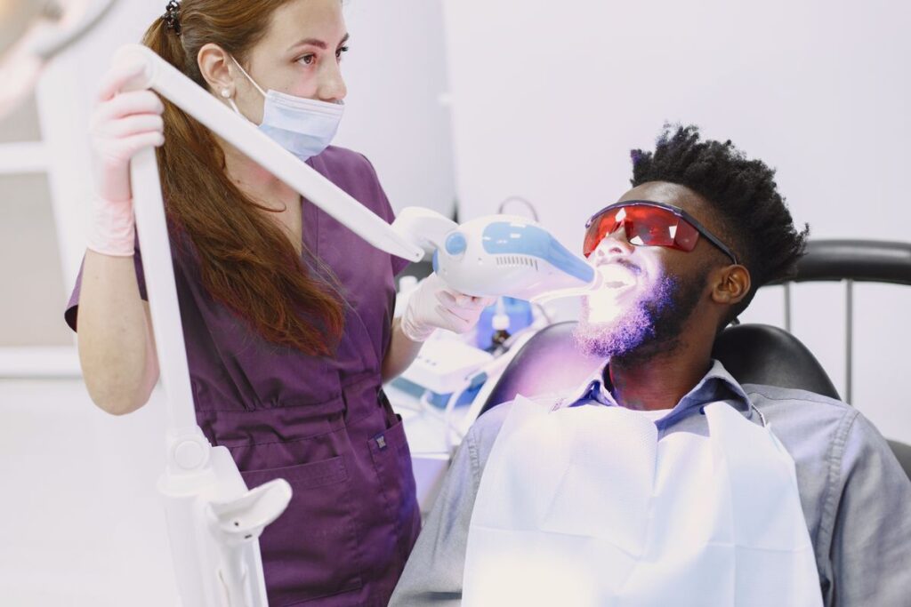 Dentist performing professional teeth whitening in North York