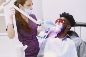 Dentist performing professional teeth whitening in North York